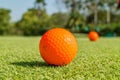 Close up the dirt golf ball on grass with blurred green golf course background.
