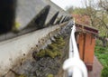 Close up on Dirt in House Roof Gutter. Asbestos Roof Gutter Cleaning