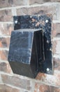 Close up of a dirty, black dryer vent hood cover Royalty Free Stock Photo