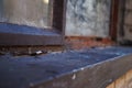 Close up of a dirty broken boarded up window sill on an abandoned building Royalty Free Stock Photo