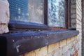 Close up of a dirty broken boarded up window sill on an abandoned building Royalty Free Stock Photo