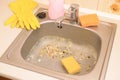Close up on dirty clogging kitchen sink drain with food particles Royalty Free Stock Photo
