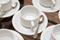 Close up dirty coffee cup and spoon setting on white saucer and wooden table after drinking in the morning in vintage style. cup Royalty Free Stock Photo