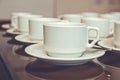 Close up dirty coffee cup and spoon setting on white saucer and wooden table after drinking in the morning in vintage style. cup Royalty Free Stock Photo