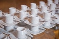 Dirty coffee cup and spoon setting on white saucer and wooden table after drinking in the morning in vintage style. Royalty Free Stock Photo