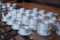 Dirty coffee cup and spoon setting on white saucer and wooden table after drinking in the morning in vintage style Royalty Free Stock Photo