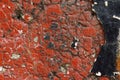 Close up of dirty, crumbling, red concrete wall