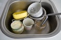 close up of dirty dishes in kitchen sink, pile of utensils need wash, a lot of tableware Royalty Free Stock Photo