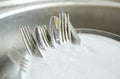 Close up of dirty dishes washing in kitchen sink Royalty Free Stock Photo