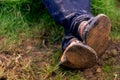 Close up of dirty feet feet crossed and resting on the ground. Famer\'s feet Royalty Free Stock Photo