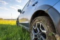 Close up of dirty off road car wheels with dirty tires covered with yellow mud