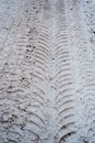 Close-up of dirty snow in winter in the city. Traces of the wheels of the car`s tread on the snow.