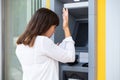 Stressed Woman Looking At Her Bank Account Balance At ATM Royalty Free Stock Photo