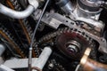 Close-up on a disassembled engine with a view of the gas distribution mechanism, chain, gears and tensioners during repair and