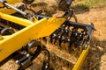 Close up of a disc harrow cultivator at work on a field with stubble Royalty Free Stock Photo
