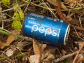 Close up discarded pepsi can rubbish on forest floor