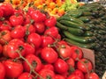 Close up of a display of colourful fruit and vegetables on a market stall.