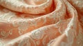 A close-up display of a Peach Fuzz brocade fabric, focusing on the rich, decorative patterns and soft peach color, fully