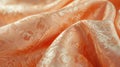 A close-up display of a Peach Fuzz brocade fabric, focusing on the rich, decorative patterns and soft peach color, fully Royalty Free Stock Photo