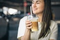 Close-up, disposable cup of iced coffee in female hands. Royalty Free Stock Photo