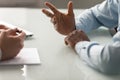 Close up diverse businessman hands talking at meeting.