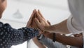 Close up diverse colleagues joining hands, giving high five Royalty Free Stock Photo