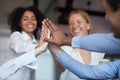 Close up diverse employees joining hand, giving high five Royalty Free Stock Photo