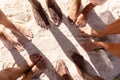 Close up of diverse friends feet at beach