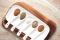 Close-up of Diverse of spices in white ceramic soup spoon over a wooden Top background.