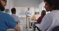 Close up of diverse students sitting at desk and chatting during lecture in college Royalty Free Stock Photo