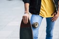 Close up of diversity young teenager concept with young teenager holding skate board and have black nails colored - casual and