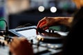 Close-up of DJ adjusting sound mixer controls Royalty Free Stock Photo