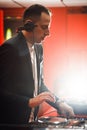 Close up of DJ with headphones at night club party Royalty Free Stock Photo