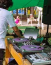 close-up dj playing music on mix console outdoor under green awning marquee. DJ mixer, DJ mix music