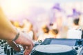 Close up of DJ`s hand playing music at turntable on a beach party festival - Portrait of DJ mixer audio in a beach club