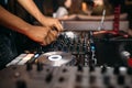 Close up of DJ`s hand playing music at turntable on a party festival - Portrait of DJ mixer audio in a beach club above the crowd Royalty Free Stock Photo