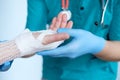 Close up of doctor bandaging one hand