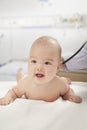 Close up of doctor checking baby's heart beat while the baby is lying down Royalty Free Stock Photo