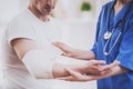 Close up. Doctor Comforting Hand Inury of Patient. Royalty Free Stock Photo