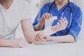 Close up. Doctor Comforting Hand Inury of Patient. Royalty Free Stock Photo