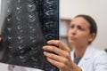 close up doctor conducts an online consultation, examining patient X-ray films and MRI scans Royalty Free Stock Photo