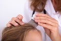 Doctor Examining Girl`s Hair Royalty Free Stock Photo