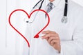 Close-up Of Doctor Hand Drawing A Heart Symbol Royalty Free Stock Photo