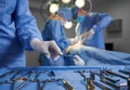 Doctors using medical instruments during plastic surgery.