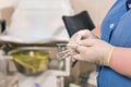 Close-up of doctor hand holds gynecological examination instruments. Gynecologist working in the obstetrics and