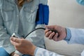 Close-up of Doctor hand measuring blood pressure of woman patient Royalty Free Stock Photo
