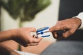 Close up of doctor hands checking pulse rates by using pulse oximeter at hospital. Royalty Free Stock Photo
