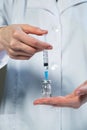 Close up doctor hands filling up syringe with antibiotic or vaccine for vaccination at hospital. Healthcare and medical Royalty Free Stock Photo