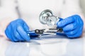 Close up of doctor hands in gloves with stethoscope, medical exam concept Royalty Free Stock Photo