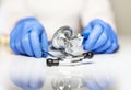 Close up of doctor hands in gloves with stethoscope, medical exam concept Royalty Free Stock Photo